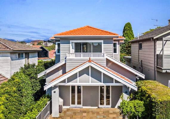 a view of a renovated 2 story house with an orange tiled roof